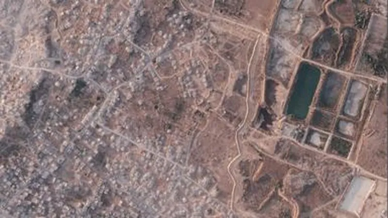 Israel is building a miles-long earthen barrier inside Gaza, entrenching its division